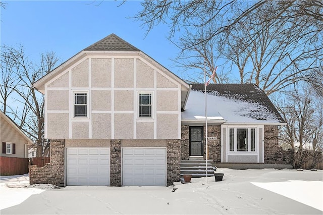 view of front of home featuring a garage, brick siding, and stucco siding