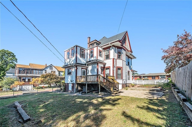 back of house with a yard, a patio, and a deck