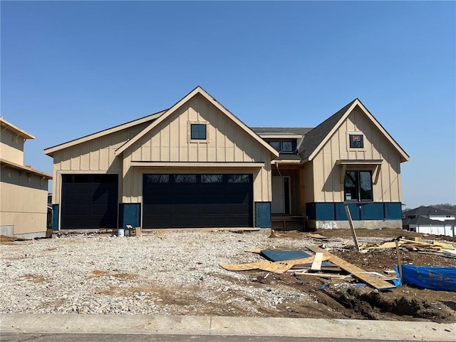 view of front of house with board and batten siding and a shingled roof