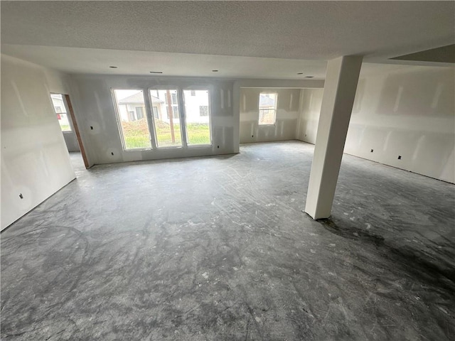 17013 Parkhill St, Overland Park, KS 66221 - unfurnished living room featuring a textured ceiling