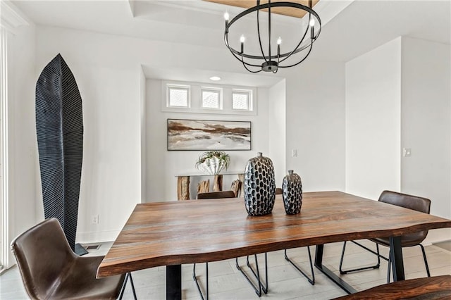 dining area with tile patterned flooring, baseboards, and a chandelier