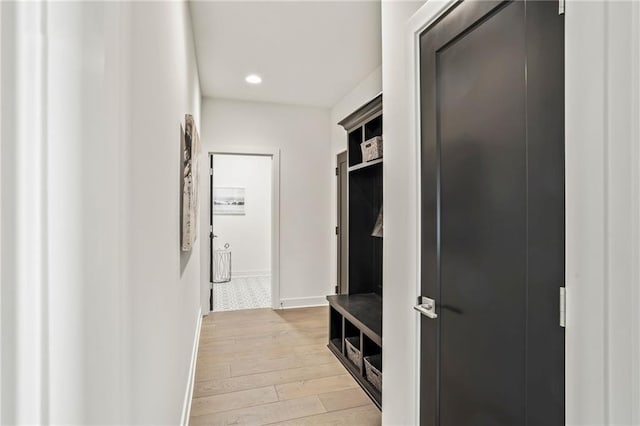 mudroom featuring light wood-style flooring, baseboards, and recessed lighting