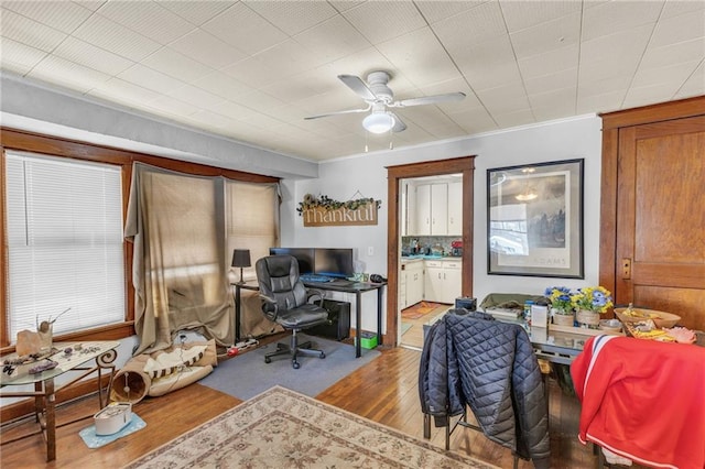 home office with a ceiling fan and light wood finished floors