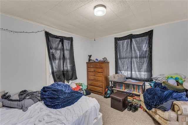 carpeted bedroom with ornamental molding