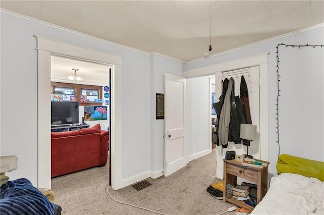 bedroom featuring light carpet, baseboards, visible vents, and crown molding