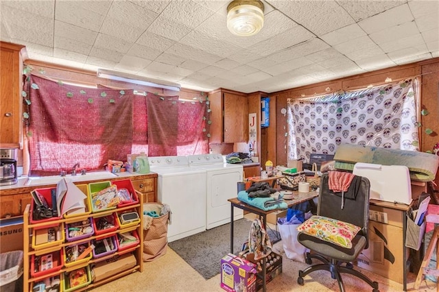 recreation room featuring washer and clothes dryer and light colored carpet