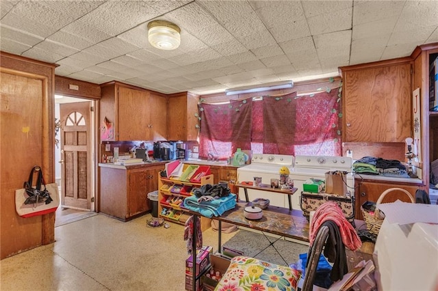 kitchen featuring light countertops, brown cabinetry, and washer and dryer