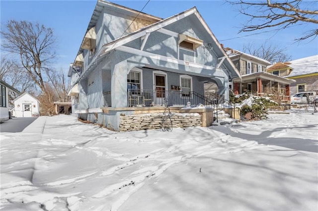 view of front of property featuring covered porch and stucco siding