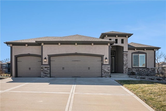 prairie-style house featuring stone siding, stucco siding, an attached garage, and driveway