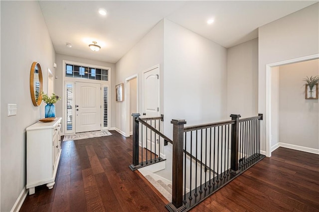 entryway with recessed lighting, baseboards, and wood-type flooring