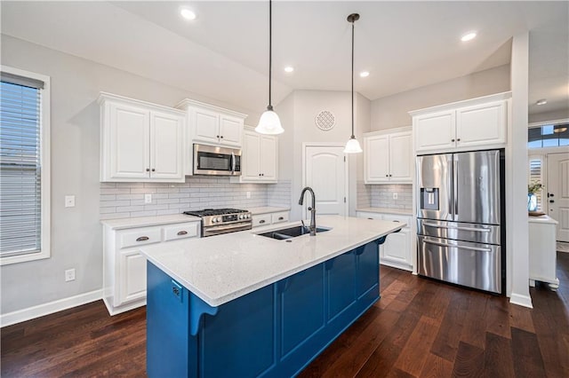 kitchen with dark wood-style flooring, white cabinets, stainless steel appliances, and a sink