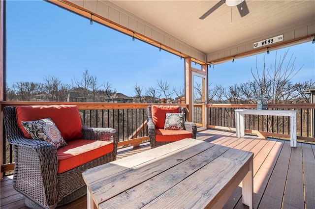 wooden terrace featuring an outdoor living space and a ceiling fan