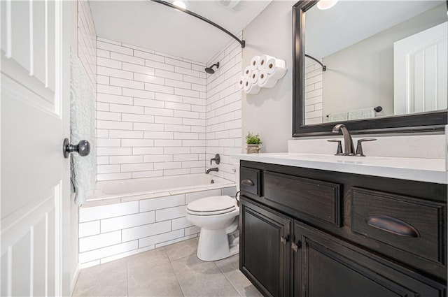 bathroom featuring tiled shower / bath combo, toilet, vanity, and tile patterned floors