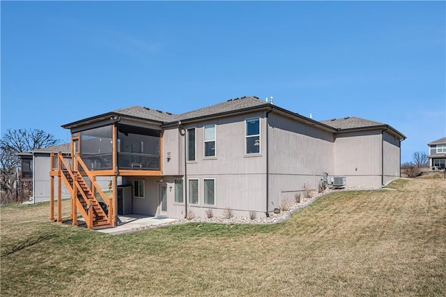 rear view of property with stairway, central AC, a yard, a sunroom, and a patio area