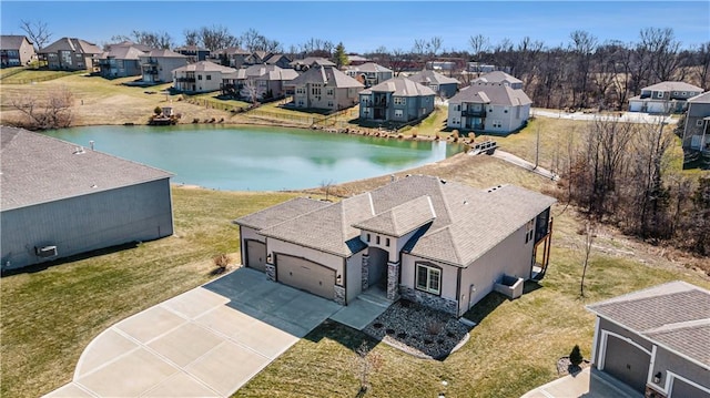 birds eye view of property featuring a residential view and a water view