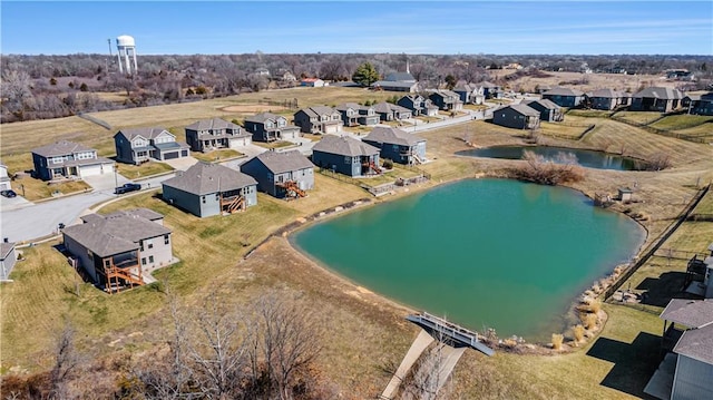 drone / aerial view featuring a residential view and a water view