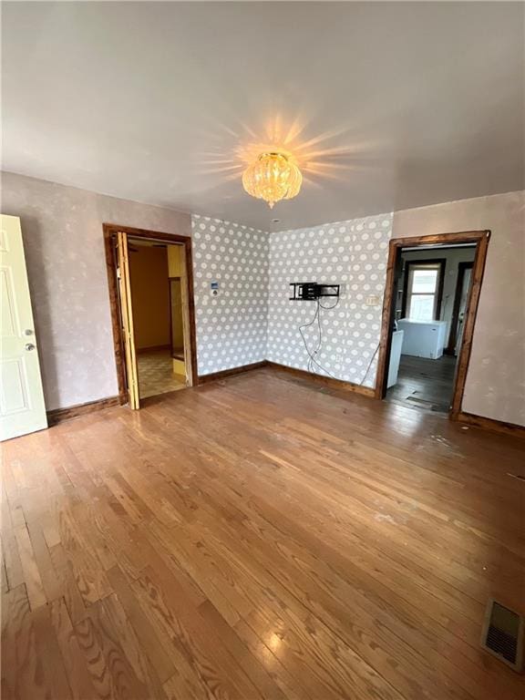 unfurnished living room featuring hardwood / wood-style flooring