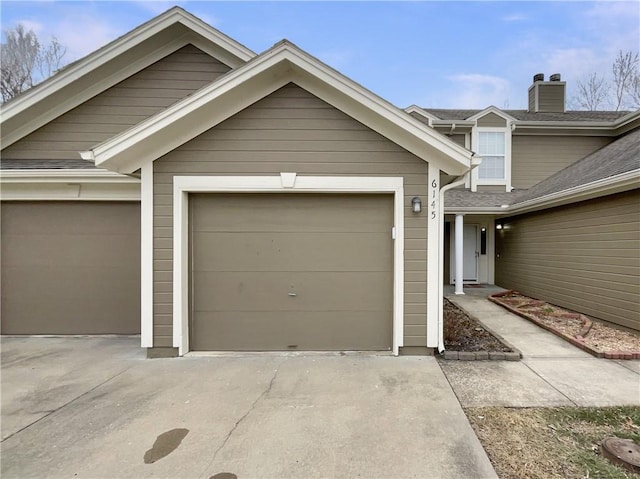 garage featuring concrete driveway