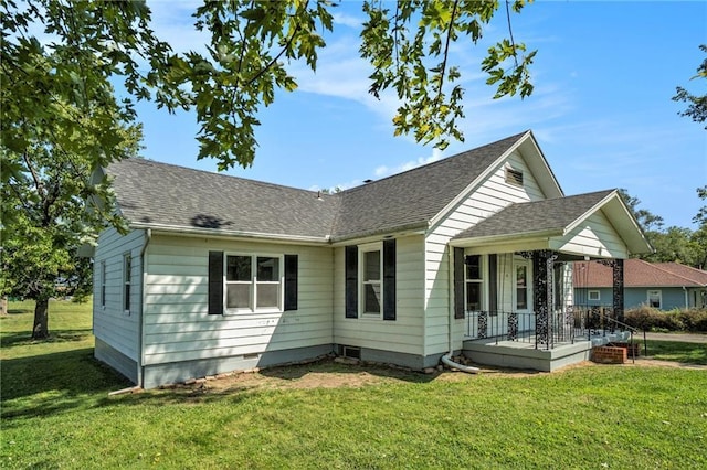 view of front of property with covered porch and a front lawn