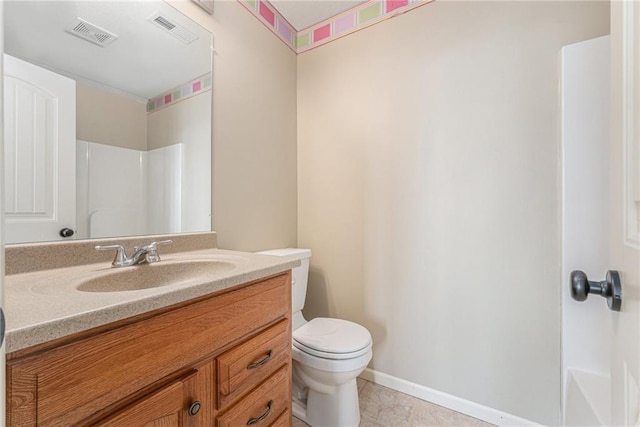 bathroom with tile patterned flooring, vanity, and toilet