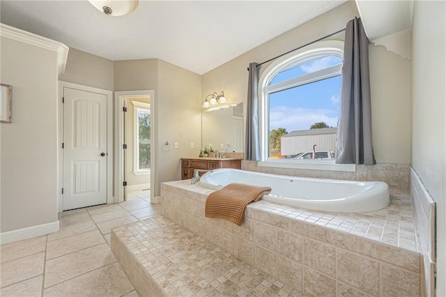 bathroom with tile patterned floors, vanity, and tiled tub