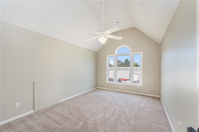 carpeted empty room featuring vaulted ceiling and ceiling fan