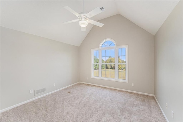 carpeted spare room featuring high vaulted ceiling and ceiling fan