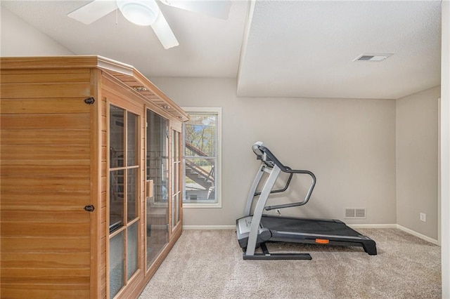 workout room with light colored carpet and ceiling fan