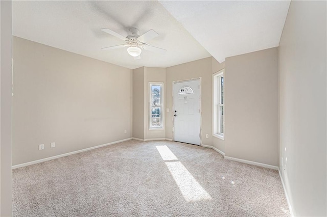 empty room with light colored carpet and ceiling fan