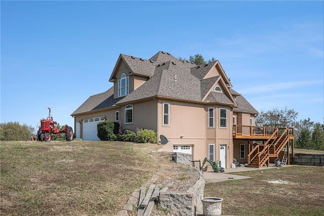 view of side of property with a yard and a deck