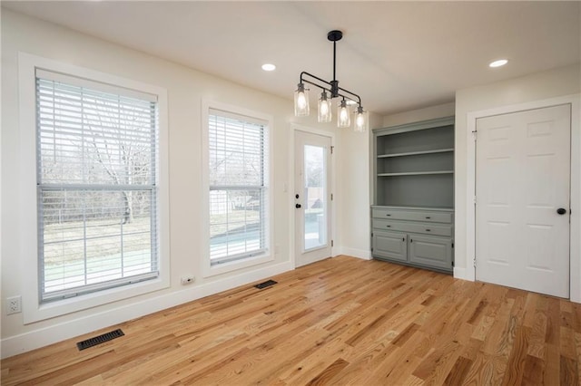 unfurnished dining area featuring visible vents, recessed lighting, baseboards, and light wood-style floors