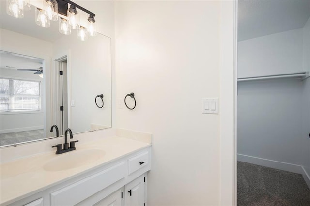 bathroom featuring vanity, a ceiling fan, and baseboards