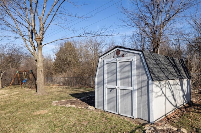 view of shed featuring a playground and fence