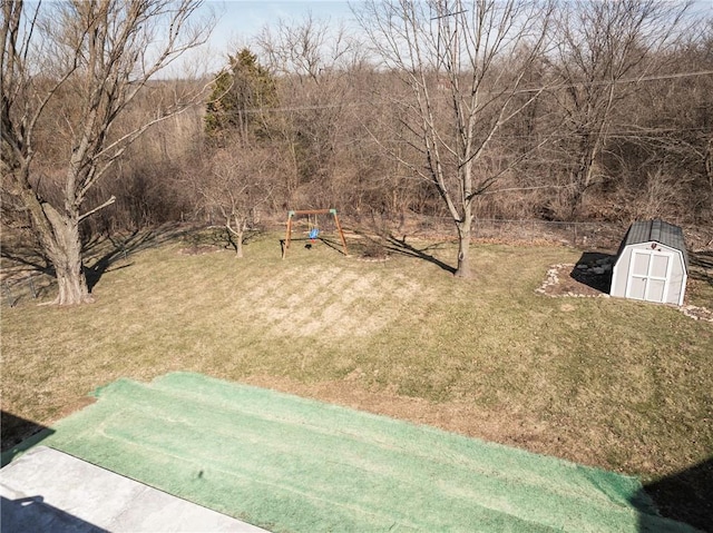 view of yard featuring an outbuilding and a shed