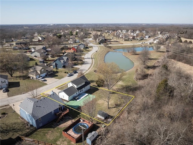 drone / aerial view featuring a residential view and a water view