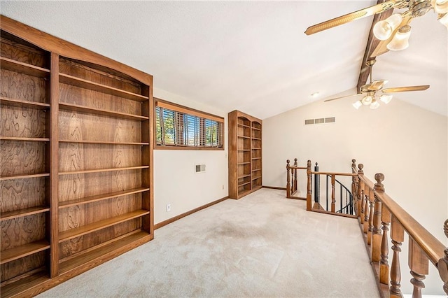 living area featuring vaulted ceiling, light carpet, and ceiling fan