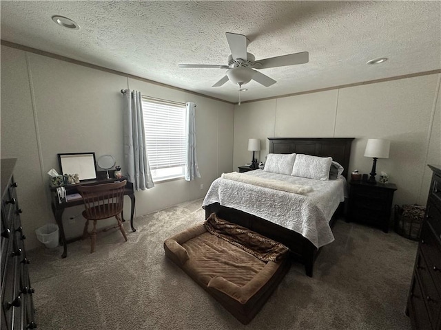 carpeted bedroom with ceiling fan, a textured ceiling, and ornamental molding