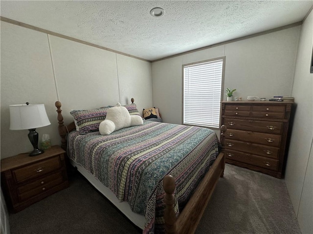 bedroom featuring dark carpet and a textured ceiling