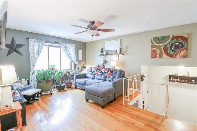 living room featuring wood-type flooring and ceiling fan