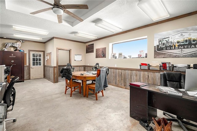 office with ceiling fan, ornamental molding, a textured ceiling, and wood walls