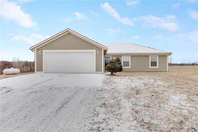 ranch-style home featuring concrete driveway and an attached garage