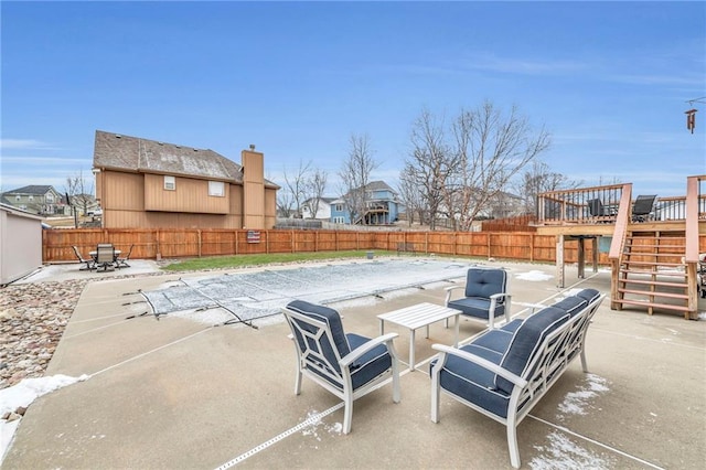 view of patio with stairway and a fenced backyard