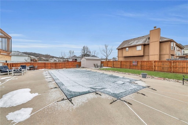 view of swimming pool with a patio area and a fenced backyard