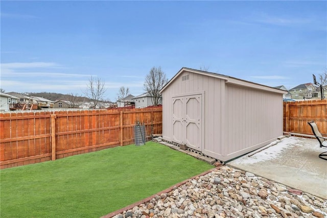 view of shed with a fenced backyard and a residential view