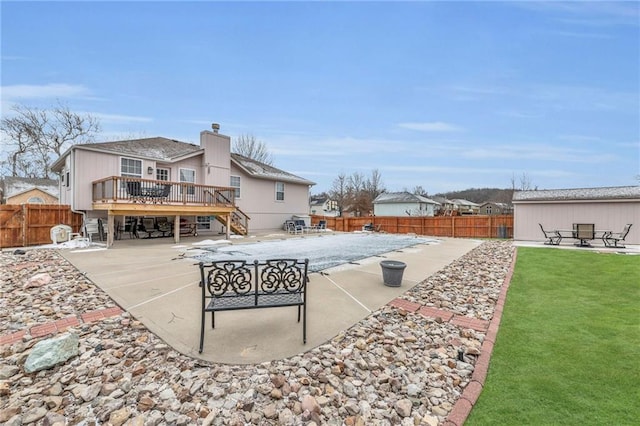 rear view of property with a patio area, a fenced backyard, and a deck