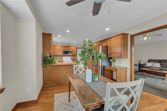 dining space featuring baseboards, visible vents, a ceiling fan, light wood-style floors, and recessed lighting