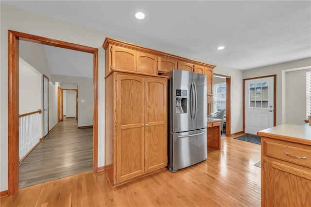 kitchen with recessed lighting, baseboards, light countertops, stainless steel fridge with ice dispenser, and light wood finished floors