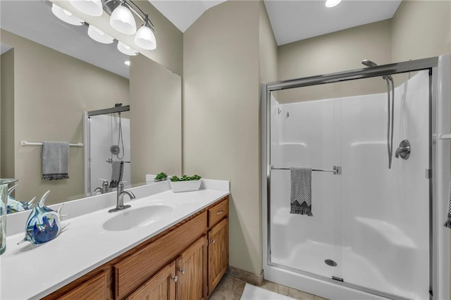 bathroom featuring a shower stall and vanity