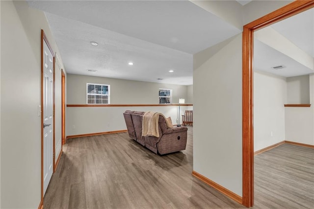 interior space featuring light wood-style flooring, visible vents, and baseboards