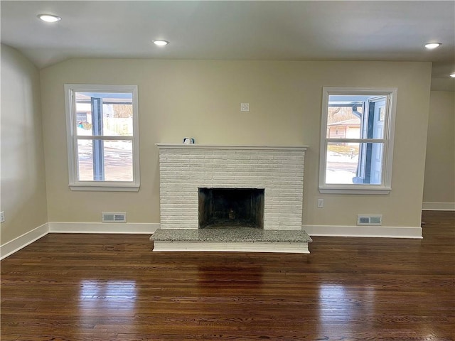 unfurnished living room featuring lofted ceiling, dark hardwood / wood-style flooring, and a fireplace